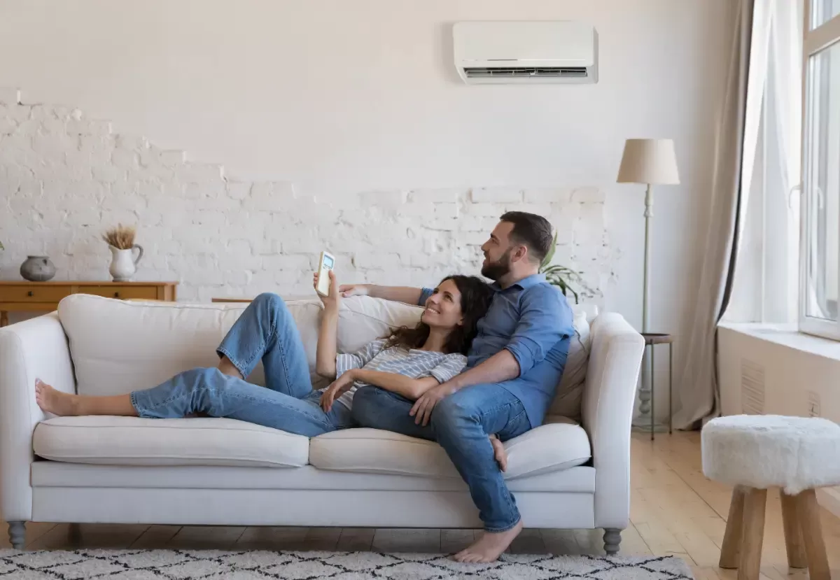Couple on couch enjoying air conditioning